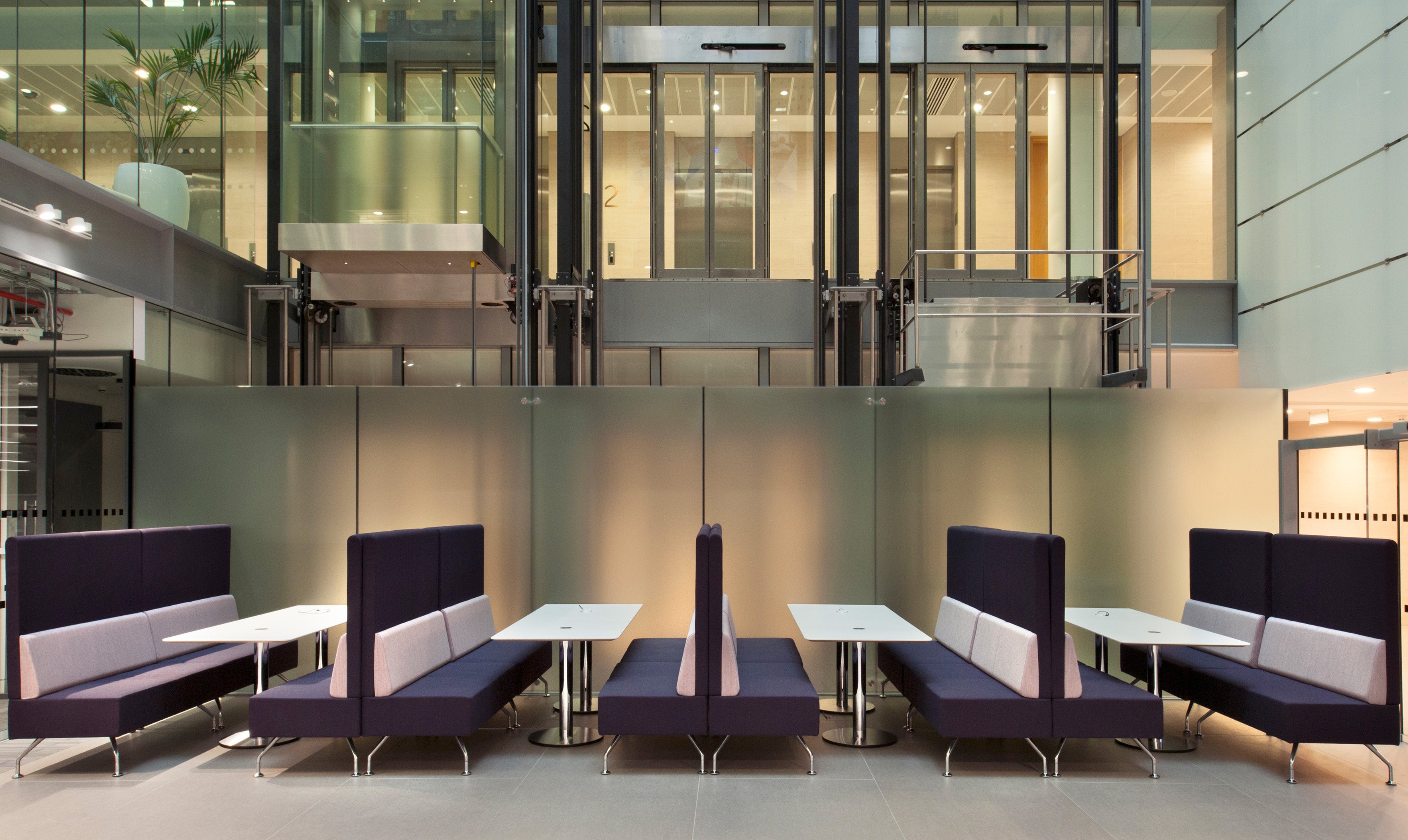 Modern office interior with purple and white seating arrangements.