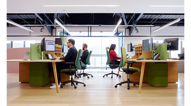 Modern office space with green and brown desks and chairs. rental office