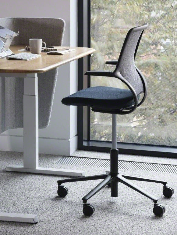 Chair at a height adjustable desk rental office work from home